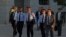 FILE - Catalan regional police chief Josep Luis Trapero, 3rd left, arrives at the national court in Madrid, Oct. 6, 2017. 