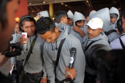 FILE - Cambodian trafficked fishermen return from Indonesia after being freed or escaping from slave-like conditions on Thai fishing vessels, at the Phnom Penh International airport, Dec. 12, 2011. (AFP)
