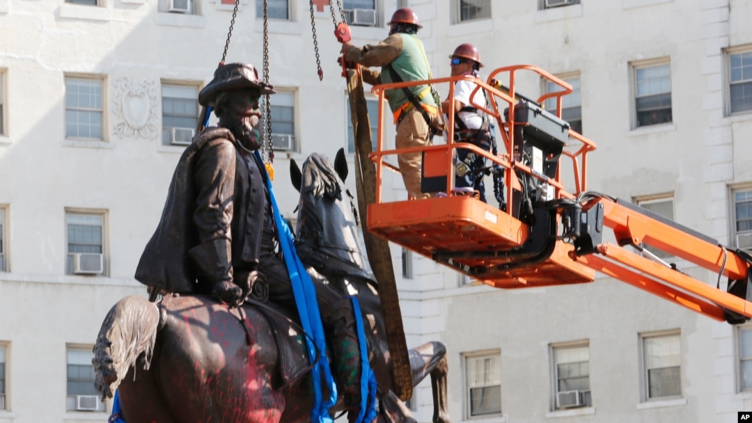 Crews remove a statue of Confederate General J.E.B. Stuart on Monument Avenue July 7, 2020, in Richmond, Va.