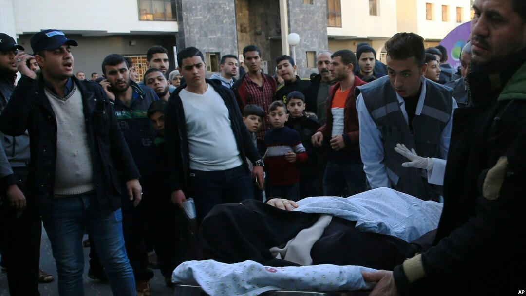 Palestinian medics move a wounded woman, who was shot by Israeli troops during a protest at the Gaza Strip's border with Israel, into the treatment room of Shifa hospital in Gaza City, Friday, Feb. 8, 2019.