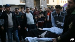 Palestinian medics move a wounded woman, who was shot by Israeli troops during a protest at the Gaza Strip's border with Israel, into the treatment room of Shifa hospital in Gaza City, Friday, Feb. 8, 2019.