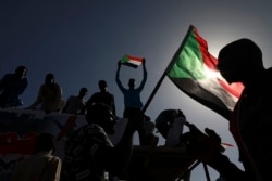 FILE - People gather as they celebrate the first anniversary of mass protests that led to the ouster of former president and longtime autocrat Omar al-Bashir, in Khartoum, Sudan, Dec. 19, 2019.