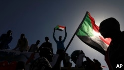 People gather as they celebrate the first anniversary of mass protests that led to the ouster of former president and longtime autocrat Omar al-Bashir, in Khartoum, Sudan, Dec. 19, 2019.