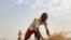 Mohammed Abdul, a farmer who said he 'had to start from the beginning' after losing all his farm inputs to violent attacks in Nigeria's north, works on a rice farm in Agatu village on the outskirts of Benue State in northcentral Nigeria, January 5, 2022. 