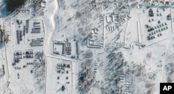 This satellite images provided by Maxar Technologies shows troops gathered at a training ground in Pogonovo, Russia, Jan.  26, 2022.