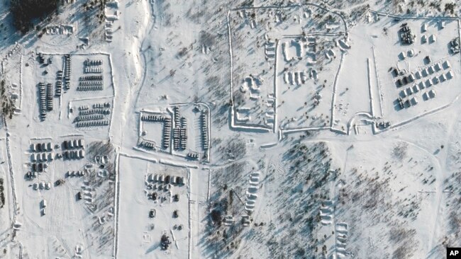 This satellite images provided by Maxar Technologies shows troops gathered at a training ground in Pogonovo, Russia, on Jan. 26, 2022.