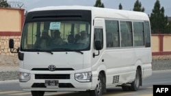 A bus carrying Laghman University students drives along a road before entering the main gate in Mihtarlam, Laghman province, Feb. 2, 2022.