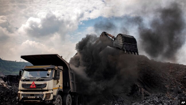 FILE - Coal is loaded into a truck at an open-cast mine near Dhanbad, an eastern Indian city in Jharkhand state, Sept. 24, 2021. (AP Photo/Altaf Qadri)