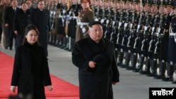 North Korean leader Kim Jong Un and wife Ri Sol Ju inspect an honour guard before leaving Pyongyang for a visit to China, this January 7, 2019 photo released by North Korea's Korean Central News Agency (KCNA) in Pyongyang January 8, 2019.