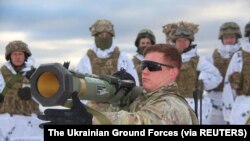 U.S. army instructor from the Joint Multinational Training Group trains Ukrainian service members to operate with M141 Bunker Defeat Munition (SMAW-D) grenade launcher, supplied by the United States, The Ukrainian Ground Forces/Handout via REUTERS