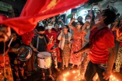 People take part in a noise campaign on the street after calls for protest against the military coup emerged on social media, in Yangon, Myanmar, on Feb. 5, 2021.