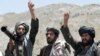 FILE - Taliban fighters react to a speech by their senior leader in the Shindand district of Herat province, Afghanistan, May 27, 2016.