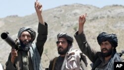 FILE - Taliban fighters react to a speech by their senior leader in the Shindand district of Herat province, Afghanistan, May 27, 2016.