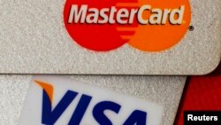 FILE - MasterCard and VISA credit cards are seen in this illustrative photograph taken in Hong Kong, Dec. 8, 2010.