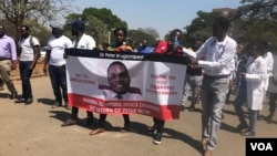 Doctors and nurses in Zimbabwe protest the disappearance of Peter Gabriel Magombeyi, acting president of the Zimbabwe Hospital Doctors Association, in Harare, Sept. 17, 2019. (C. Mavhunga/VOA)