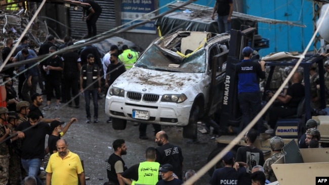 Lebanese army soldiers and rescuers work in a street under a residential building whose top two floors were hit by an Israeli strike in the Ghobeiri area of Beirut's southern suburbs, on Sept. 24, 2024.