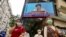 A TV screen broadcasts Hong Kong Chief Executive Carrie Lam during a news conference in Hong Kong, Tuesday, March 30, 2021. China's top legislature approved amendments to Hong Kong's constitution on Tuesday that will give Beijing more control over…