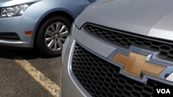 A detail of the grill of a 2011 Chevrolet Cruze compact car, right, is seen near another Chevrolet Cruze, left, on the lot of a dealership, in Norwood, Mass., Tuesday, May 31, 2011. General Motors' U.S. sales fell 1.2 percent in May as it offered fewer de