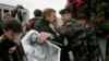FILE - Belarusian police officers clash with protesters during an opposition rally in Minsk, Belarus, Sept. 16, 2008, marking the ninth anniversary of the disappearance of Belarusian politician Viktor Gonchar and businessman Anatoly Krasovsky.
