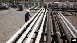 FILE - An employee works at the Tawke oil fields in the Kurdish region in northern Iraq, May 31, 2009.