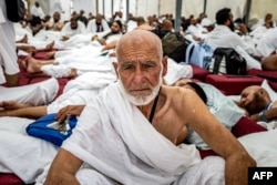 Muslim pilgrims arrive at the Mina tent camp during the annual Hajj pilgrimage, near the holy city of Mecca, Saudi Arabia, on June 14, 2024.