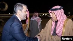 Menteri Luar Negeri Suriah yang baru ditunjuk Asaad Hassan al-Shibani (kiri) menjabat tangan Wakil Menteri Luar Negeri Arab Saudi Waleed Elkhereiji saat tiba di Riyadh, pada 1 Januari 2025. (Foto: Saudi Press Agency/Handout via Reuters)