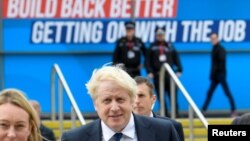 Britain's Prime Minister Boris Johnson walks through the Conservative Party annual conference venue, in Manchester, Britain, Oct. 3, 2021.