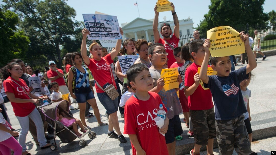 Demonstrators march following a news conference of immigrant families and children's advocates responding to President Barack Obama's position on the crisis of unaccompanied children and families illegally entering the US, in front of the White House in W