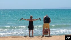 German tourists arrive at the beach of Palma de Mallorca, Spain, June 15, 2020.