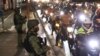 Police officers inspect motorcycle riders at a checkpoint during a stricter lockdown as a precaution against the spread of the coronavirus at the outskirts of Marikina City, Philippines on Friday, August 6, 2021. Thousands of people jammed…