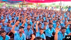 Samsung workers who are on strike shout slogans during a protest near their plant in Sriperumbudur, on the outskirts of Chennai, India, Tuesday, Sept. 24, 2024.