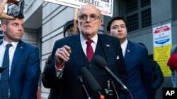 Former Mayor of New York Rudy Giuliani speaks during a news conference outside the federal courthouse in Washington on Dec. 15, 2023. A jury awarded $148 million in damages to two former election workers who sued him over lies he told about them.