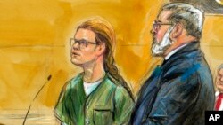 FILE - Maria Butina, left, is shown next to her attorney Robert Driscoll, in this courtroom sketch, before U.S. District Judge Tanya Chutkan at the U.S. District Court in Washington, Dec. 13, 2018.