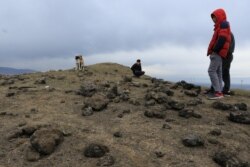 Residents look at a crater caused by a missile launched by Iran on U.S.-led coalition forces on the outskirts of Duhok, Iraq, Jan. 8, 2020.