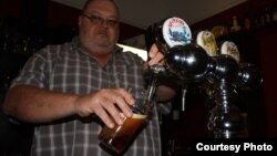 FILE - Beer is poured from a tap.