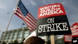 FILE - Writers Guild of America (WGA) writers and others strike against the Alliance of Motion Picture and Television Producers (AMPTP) in Los Angeles on Nov. 9, 2007. 