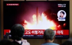 FILE - People watch a TV news program reporting about North Korea's firing projectiles with a file image at the Seoul Railway Station in Seoul, South Korea, Aug. 16, 2019.