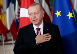 FILE - Turkish President Recep Tayyip Erdogan gestures prior to a meeting at the European Council building in Brussels, Belgium, March 9, 2020.