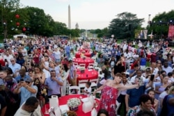 Attendees listen as President Joe Biden speaks during an Independence Day celebration on the South Lawn of the White House, in Washington, July 4, 2021.