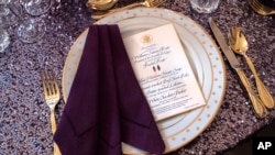 FILE—A place setting is seen atop a sequined tablecloth during a media preview, May 22, 2024, ahead of Thursday evening's State Dinner with Kenya's President William Ruto, at the White House in Washington.