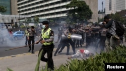 FILE - Police clash with protesters who gathered to rally against Indonesia's rule over the remote eastern Indonesian province of Papua, Dec. 1, 2015.