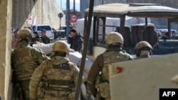 FILE - Russian soldiers gather in the government-held side of the embattled city of Aleppo before the start of an evacuation operation of rebel fighters and their families from rebel-held areas on Dec. 15, 2016. 