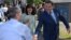 FILE - For the first time in a decade, the party of Bosnian Serb leader Milorad Dodik — who is shown shaking hands with a supporters on the day of elections last October — is not a part of the central government.