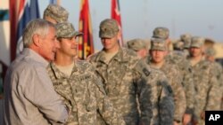 U.S. Secretary of Defense Chuck Hagel greets U.S. troops upon his arrival at Camp Buehring, Kuwait, Dec. 8, 2014.