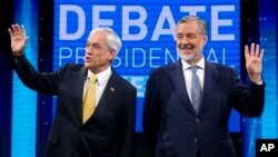 Chile Vamos candidate and former President Sebastian Pinera, left, and Nueva Mayoria or New Majority ruling party candidate Alejandro Guillier, pose for photos before the start of a live, televised presidential debate, in Santiago, Chile, Dec. 11, 2017.