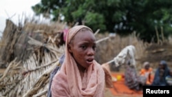 FILE - Maab, 12, a Sudanese girl who fled the conflict in Geneina in Sudan's Darfur region, who said she lost both her parents and was scarred by burns on her face after a mortar landed on her house, is pictured at a makeshift shelter in Adre, Chad July 24, 2023.