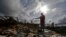 Jose Garcia Vicente holds a piece of plumbing he picked up, as he shows his destroyed home, in the aftermath of Hurricane Maria, in Aibonito, Puerto Rico, Monday, Sept. 25, 2017.
