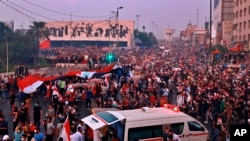 FILE - Anti-government protesters gather in Tahrir Square during a demonstration in Baghdad, Iraq, Oct. 28, 2019.