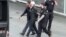 Brazilian Federal Police officers escort one of the 10 people they arrested on suspicions of belonging to a group supporting Islamic State and discussing terrorist acts during next month's Rio 2016 Olympic Games, at the Guarulhos airport in Sao Paulo, in 
