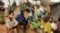 FILE - Newly arrived Mozambican refugees wait for registration at the Kapise refugee camp in the Mwanza district on the Malawian Mozambican border, Jan. 7, 2015, in Malawi.